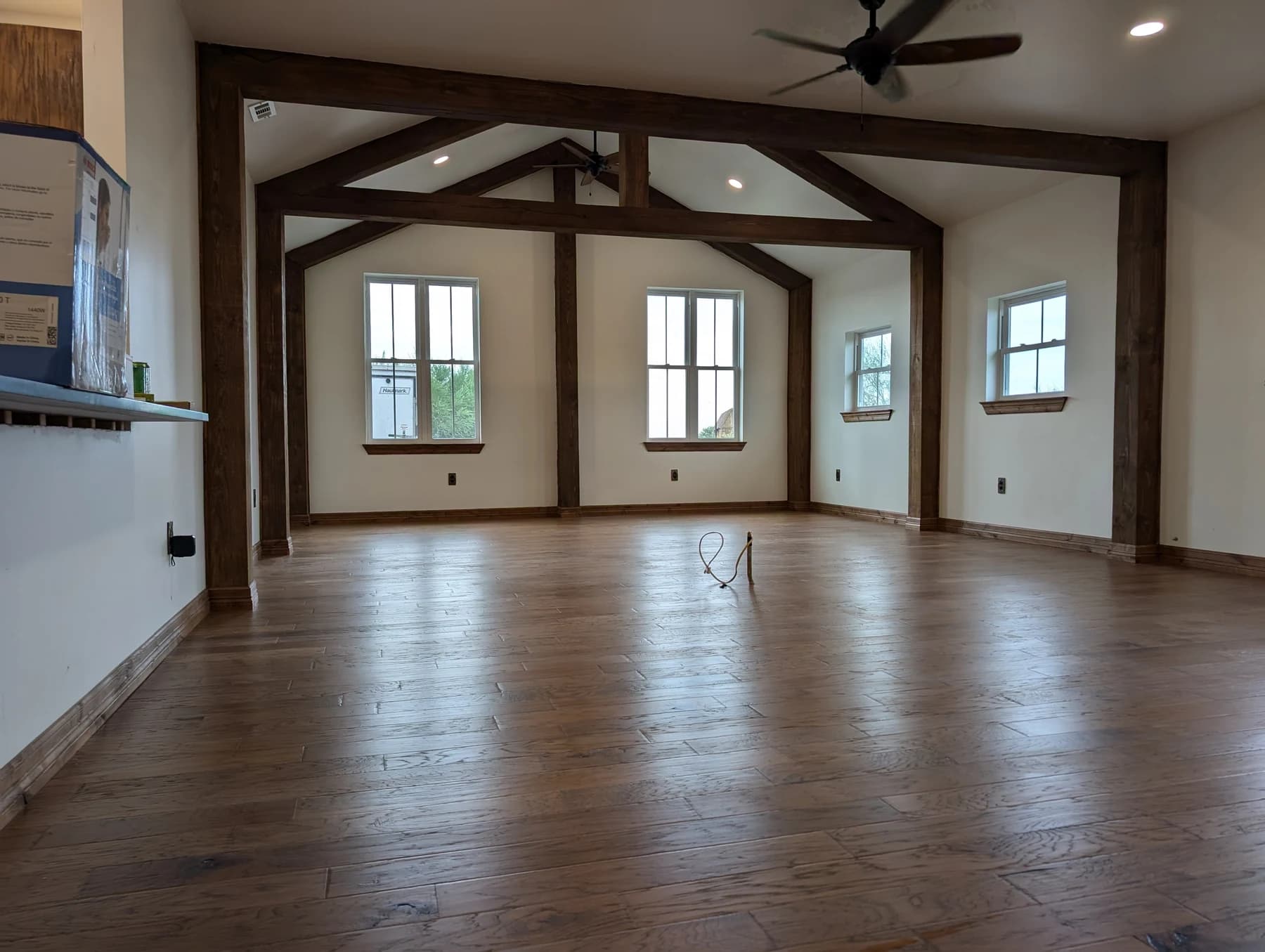 Charleston’s interior during finishing work, with exposed timber, tall windows and wood flooring