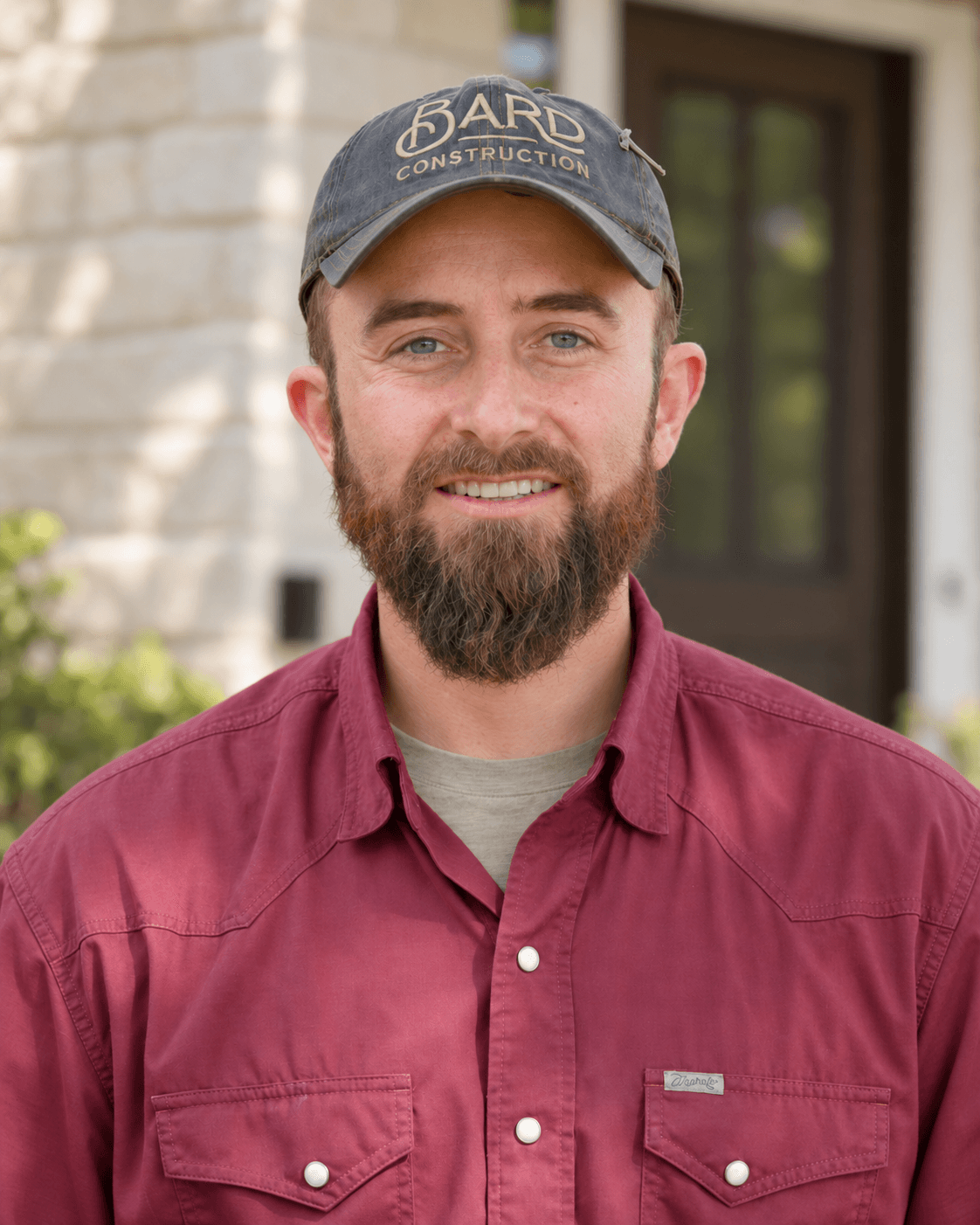 Portrait of Robert Brace wearing his Bard Construction cap and burgundy work shirt